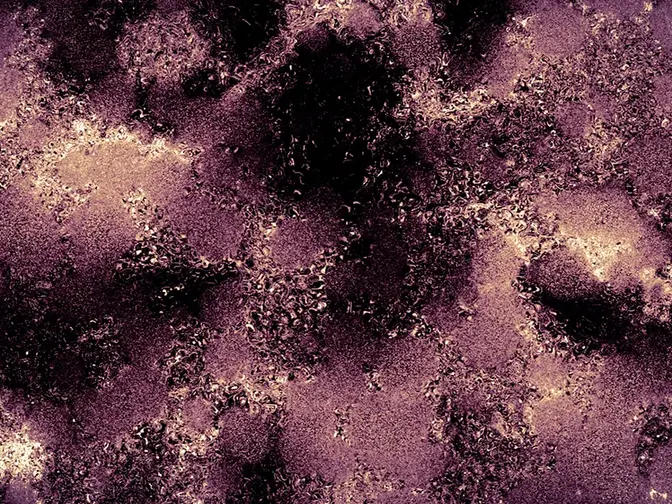 A blotchy closup of a surface, purple, redish, brown black